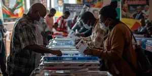 Cameroon Election: voters participating in 2025 election, election officials, and campaign activities in a realistic setting